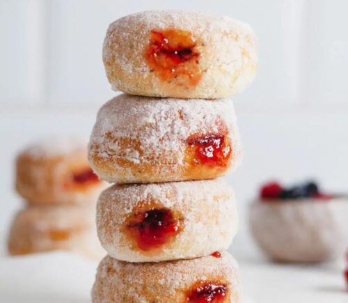 A stack of baked dairy-free donuts filled with sweet vegan jam