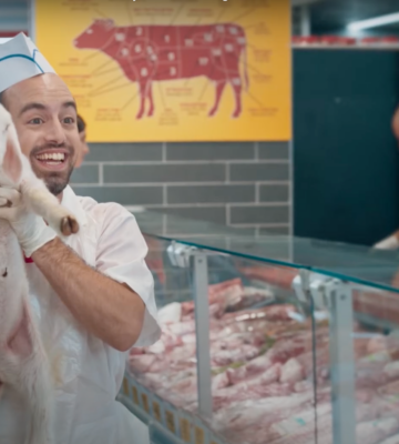 A man holds up a live lamb at a butchers counter, as part of the Vegan Friendly viral advert which first screened in Israel last year
