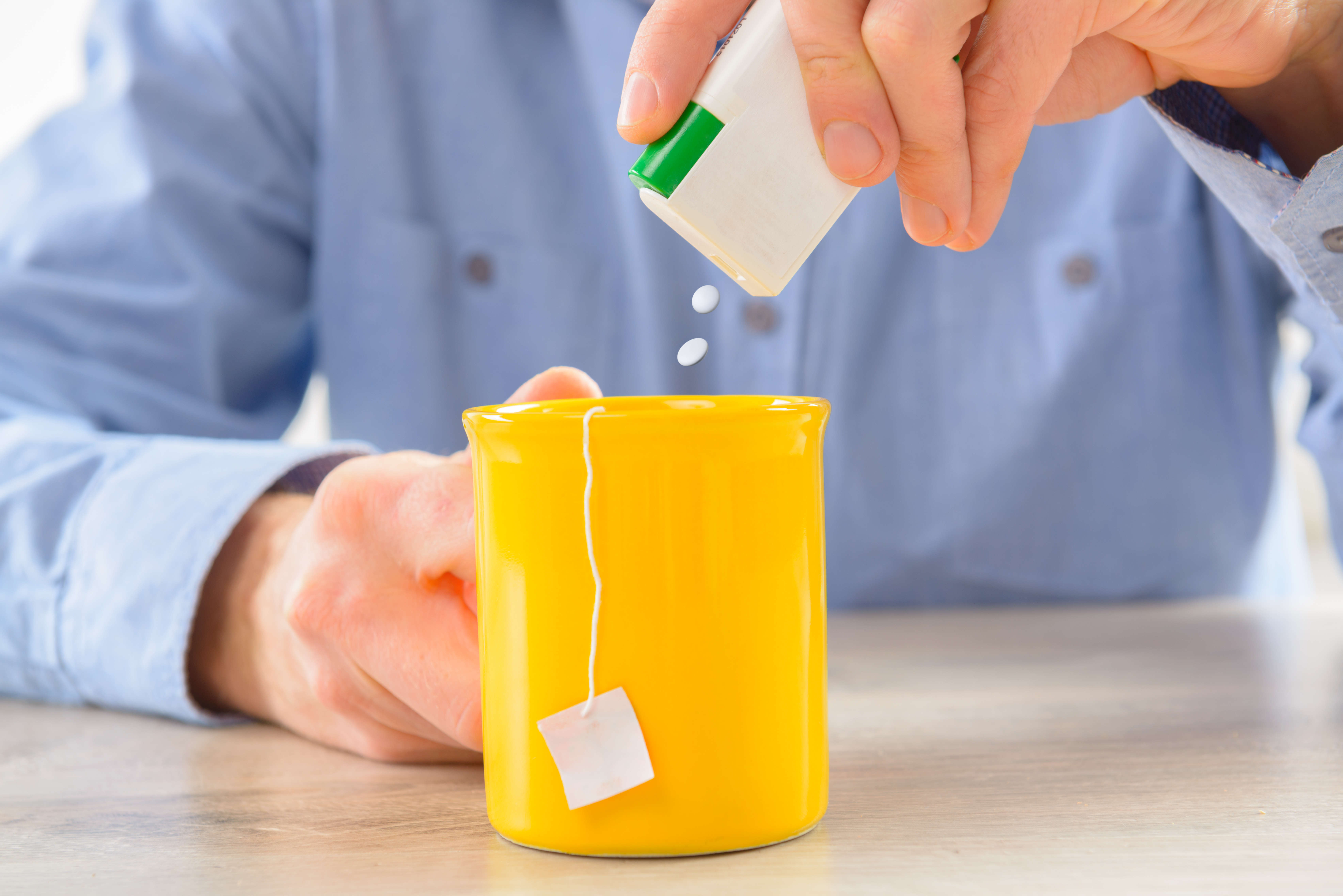 Aspartame, a common sweetener, being used in a cup of tea