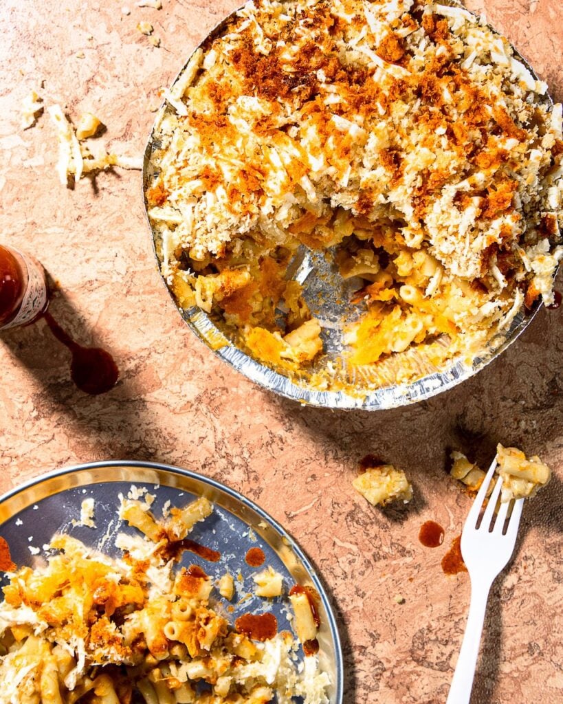 Freshly served vegan butternut Mac 'n' cheese from Zacchary Bird, dished up from an aluminium baking tray