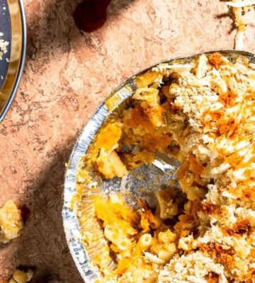 Freshly served vegan butternut Mac 'n' cheese from Zacchary Bird, dished up from an aluminium baking tray