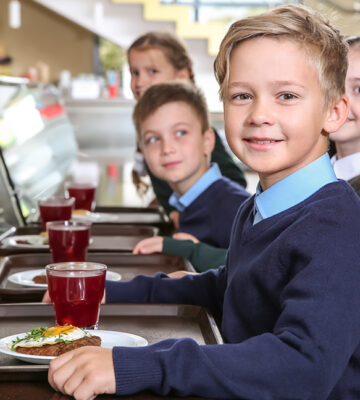 Children in a school cafeteria - where red meat has been banned in new york
