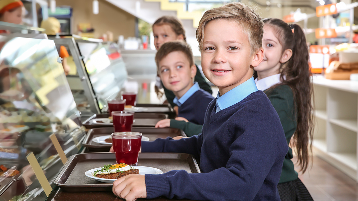 Children in a school cafeteria - where red meat has been banned in new york