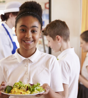 A child being served food at school