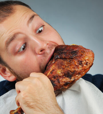 Man eating chicken, which is causing deforestation