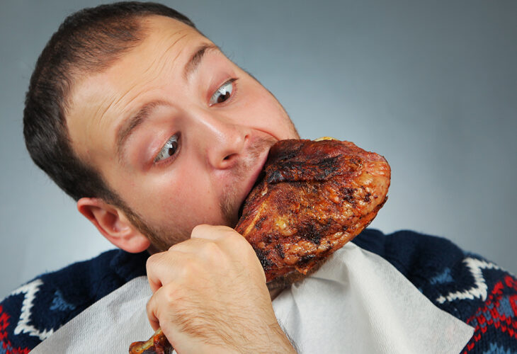 Man eating chicken, which is causing deforestation