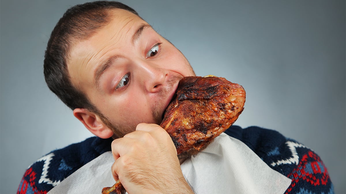Man eating chicken, which is causing deforestation