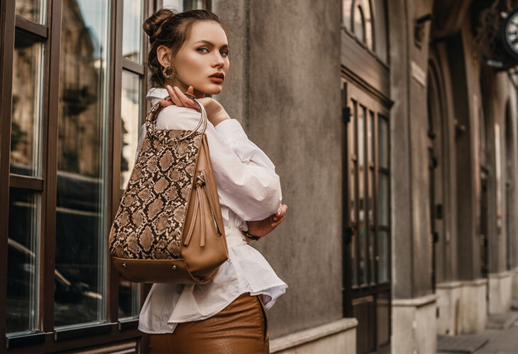 Woman holding a bag made out of exotic skins
