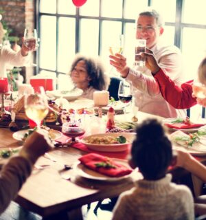 A family eat a vegan Christmas dinner at a table