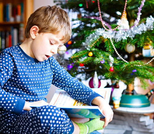 child reading book for Christmas