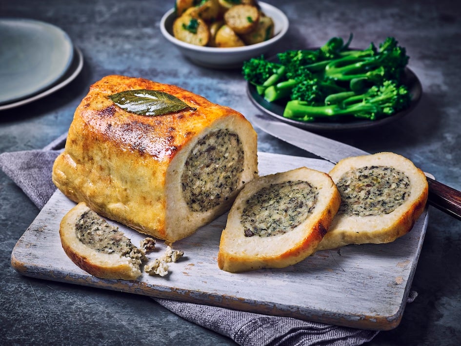 A vegan roast carved on a plate with stuffing, part of Marks & Spencers' Plant Kitchen dine-in deal for Mother's Day