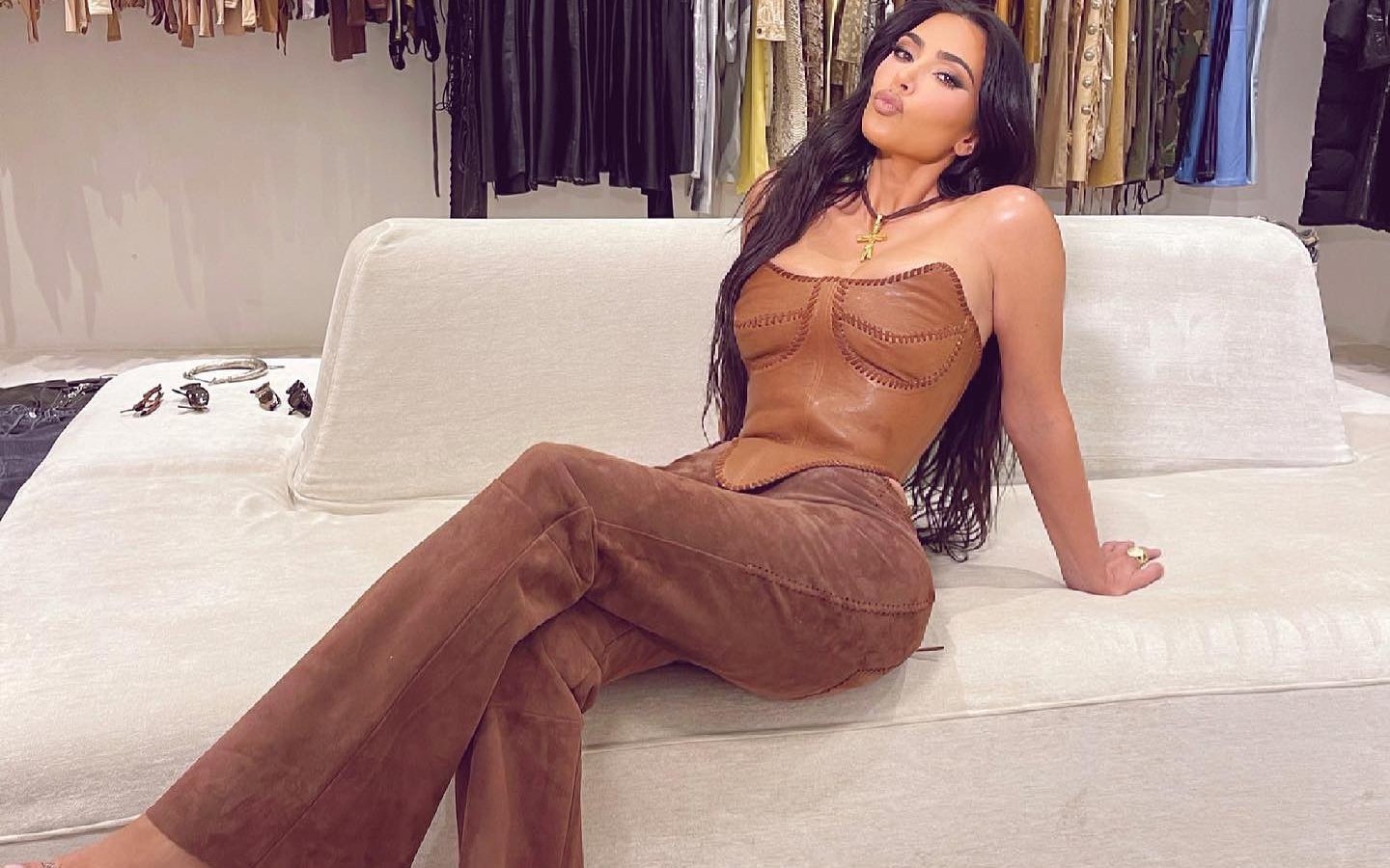 Kim Kardashian poses on sofa