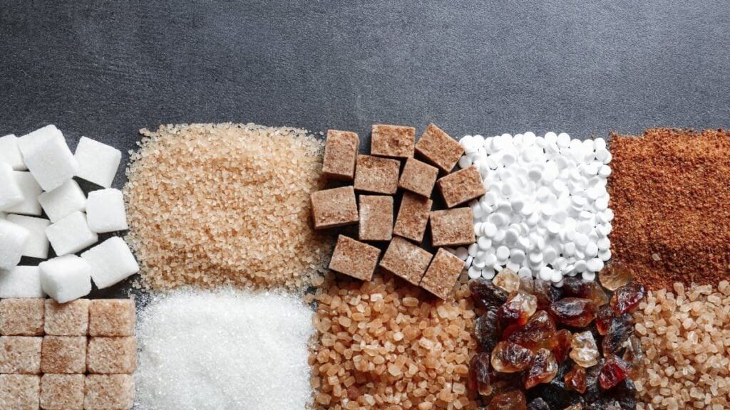 Cubes and piles of sugar grains and artificial sweeteners