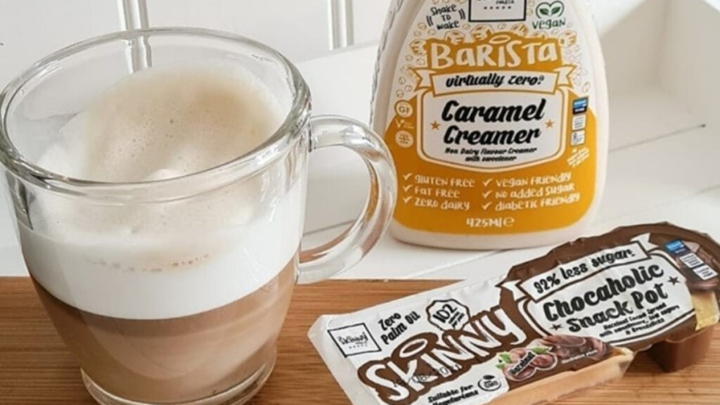 Plant-based creamer made by Skinny Food Co beside a cup of vegan coffee