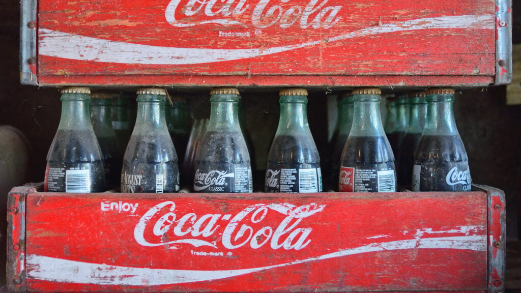 A case of Coke, a soda made by Coca-Cola that is vegetarian and vegan