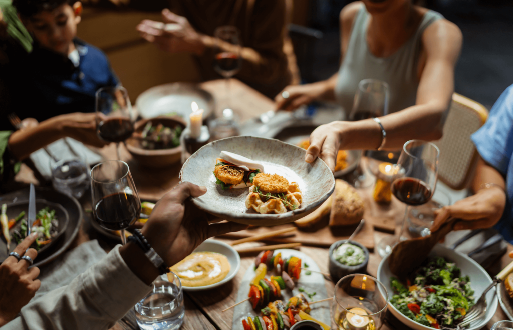 Plates of food featuring cultured meat passed around at a restaurant