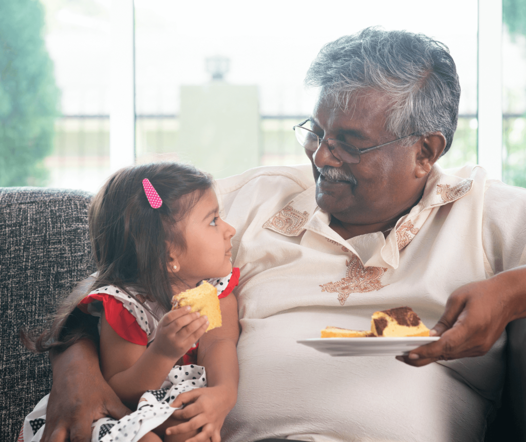 grandparent and granddaughter sharing food together