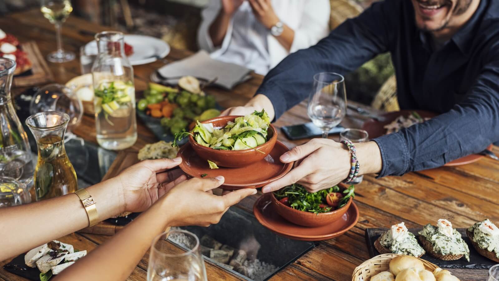 people handing plant-based food to each other