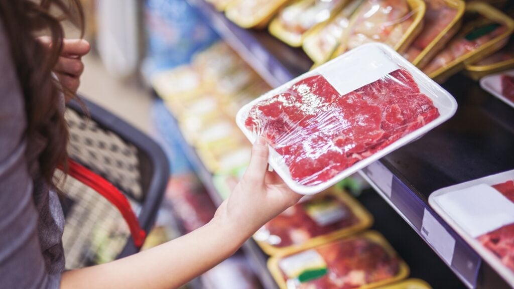 shopper looking at meat in a supermarket