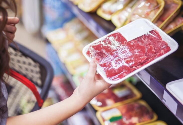 shopper looking at meat in a supermarket