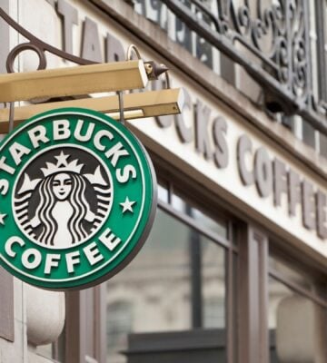 Starbucks sign hanging from a store front in London