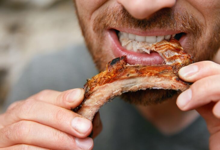 A man eating meat
