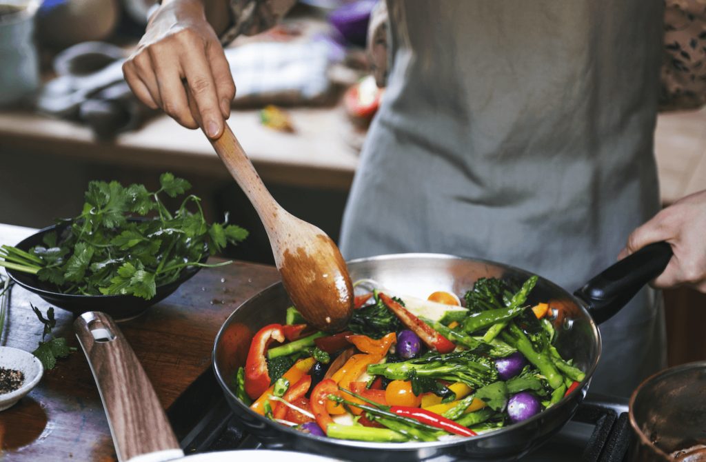 A person cooking vegetables