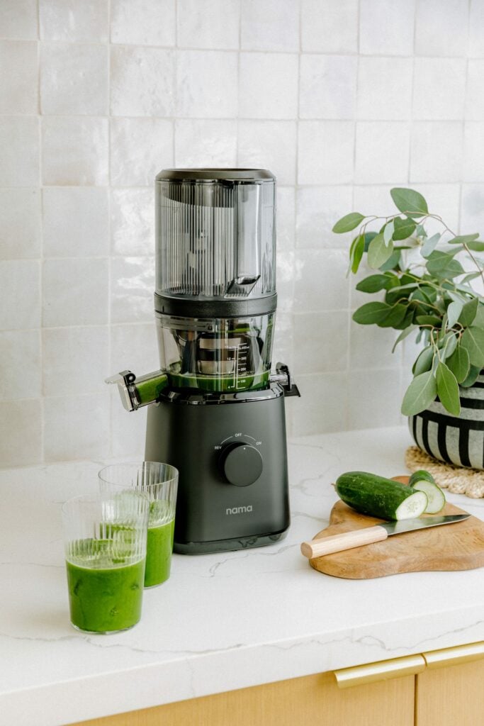 A Nama J2 Cold-Pressed Juicer making vegan smoothies with plant-based ingredients