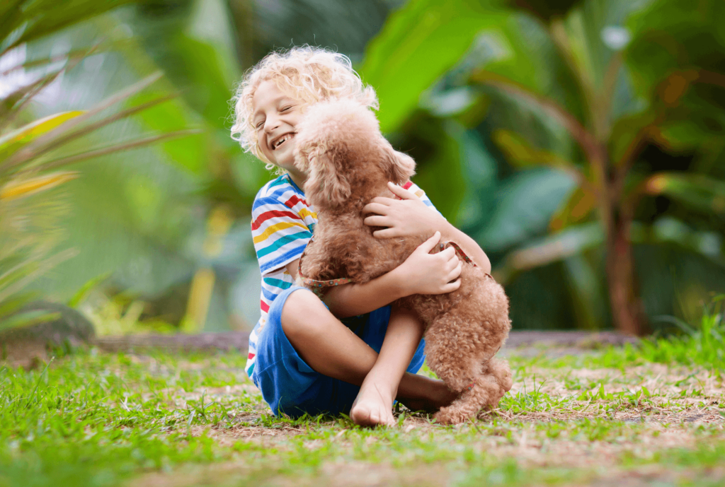 Child playing with dog