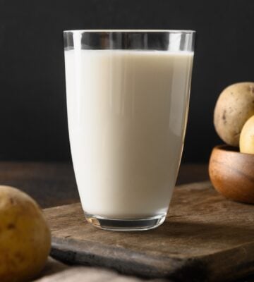 Vegan potato milk and potato on brown background