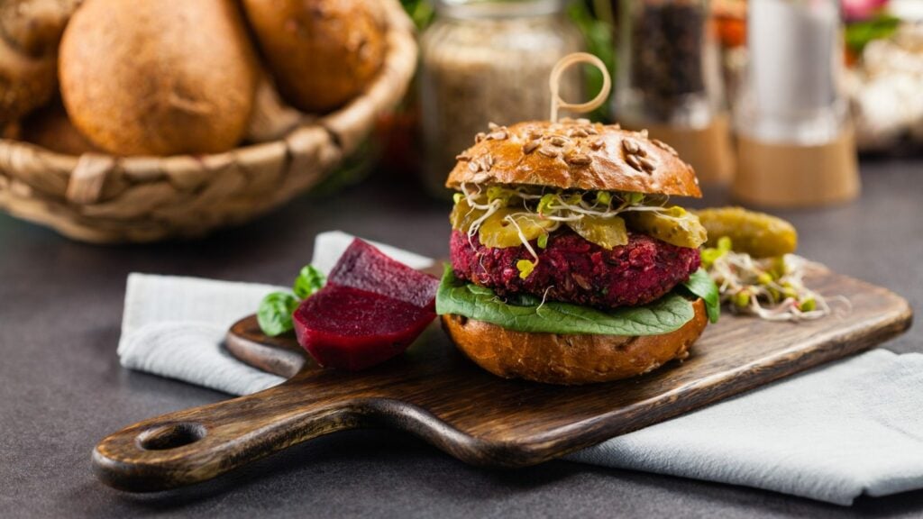 A bright purple/red vegan burger