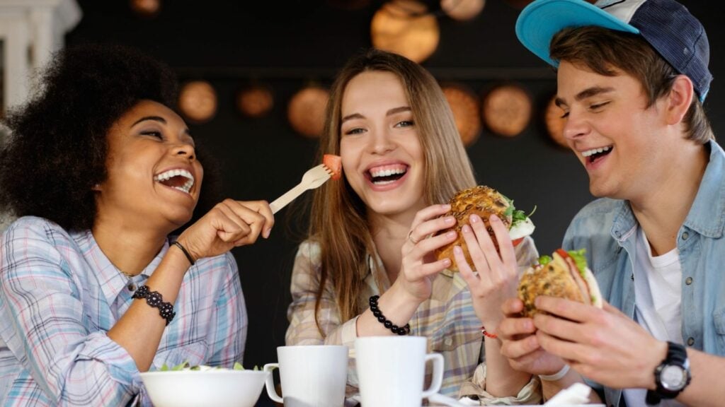 friends eating burgers and laughing