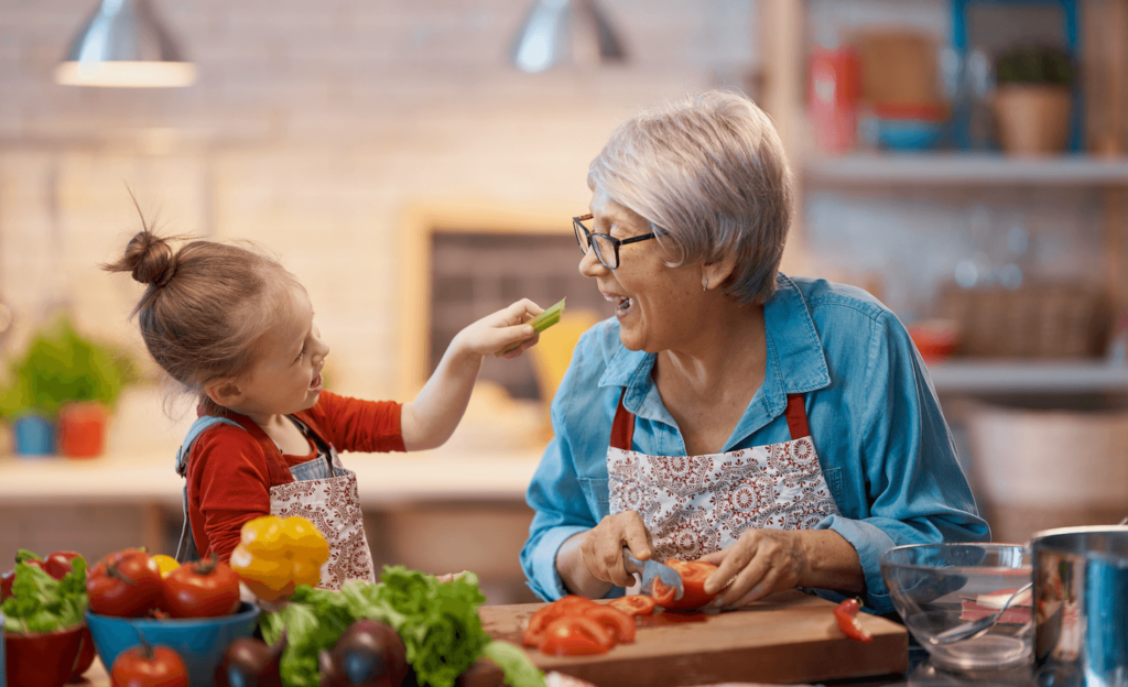 A grandmother and child cooking in the kitchen