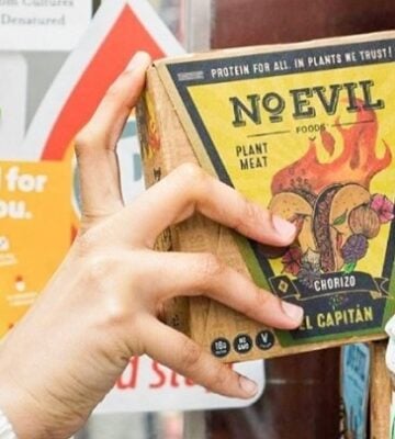 a person takes a box of No Evil Foods off the shelf