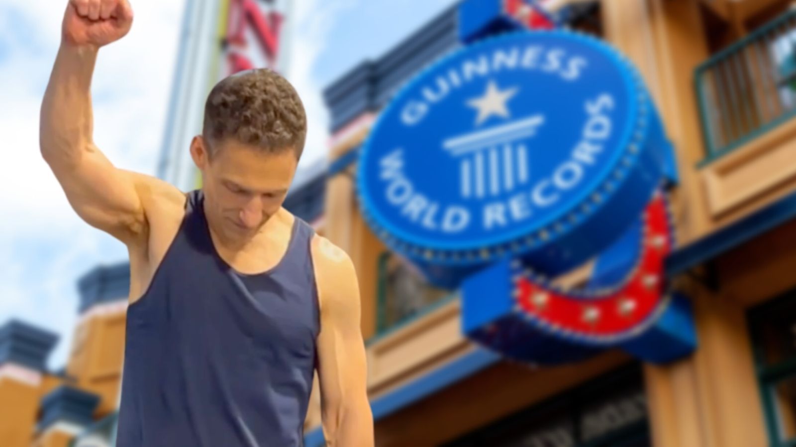 Joe DeMarco raises a fist in front of a Guinness World Records sign