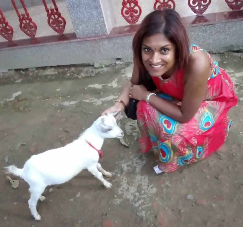 Mitali Deypurkaystha with a temple goat in India