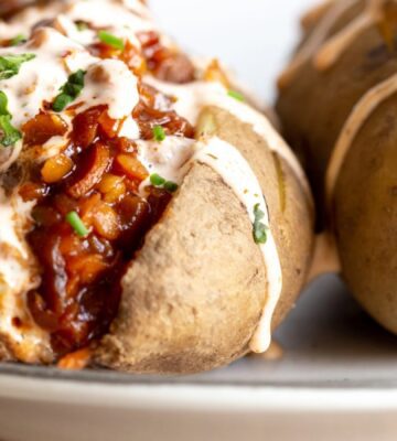 a close up of baked potato with barbecue lentils