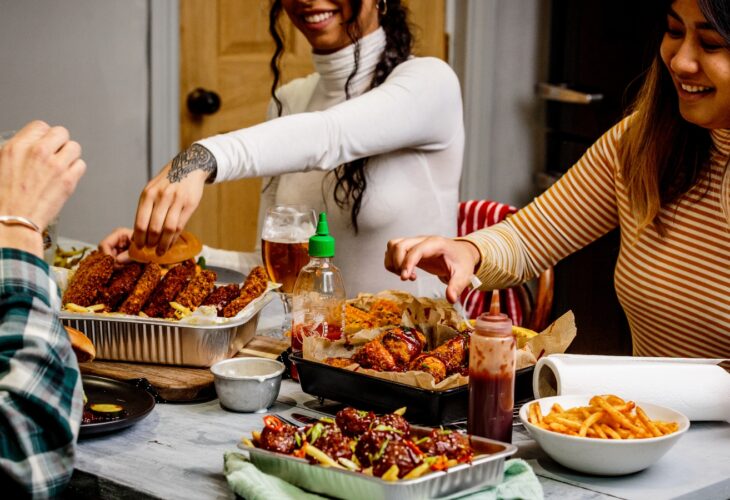 People eating vegan food together at a table