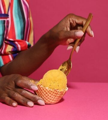 A woman scoops ice cream with a spoon