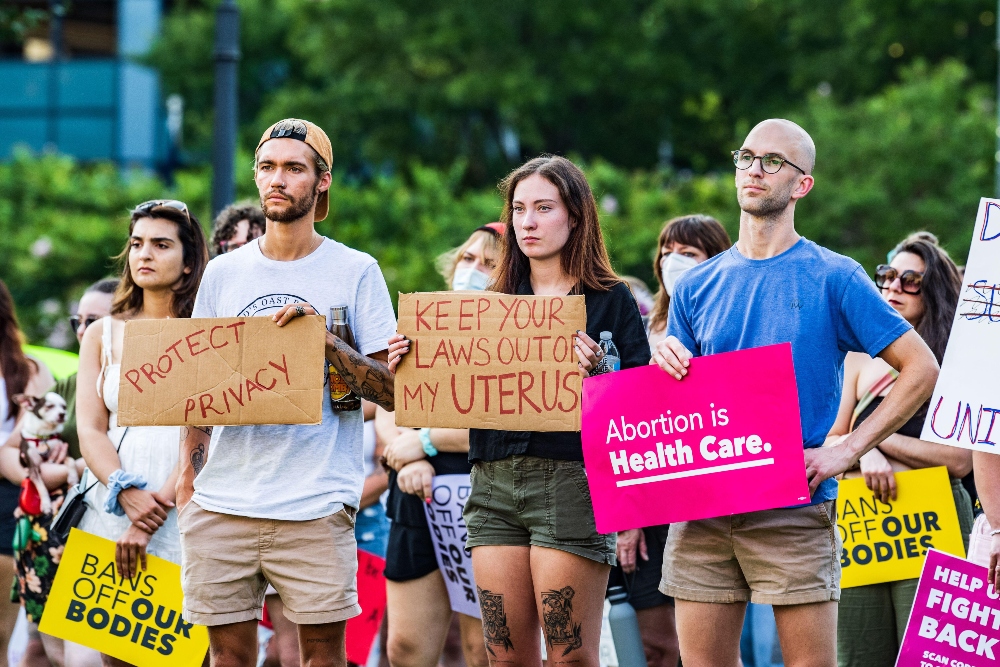 Men and women stand together at abortion protest