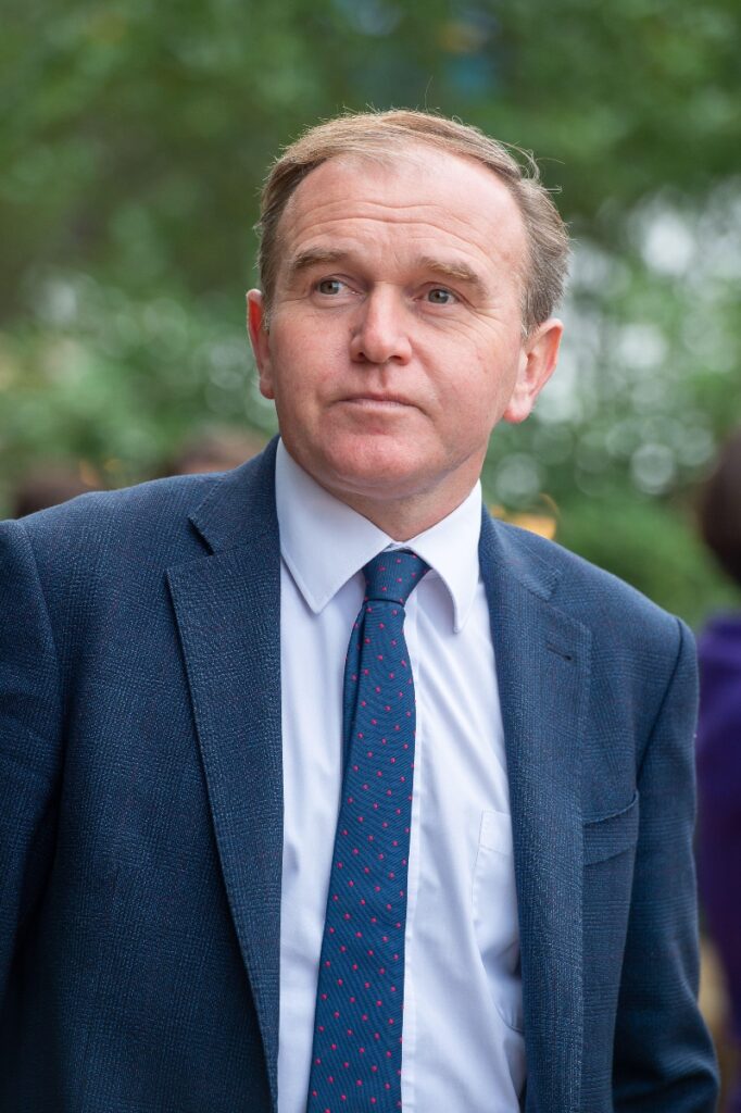 Defra Secretary of State George Eustice wearing a blue suit