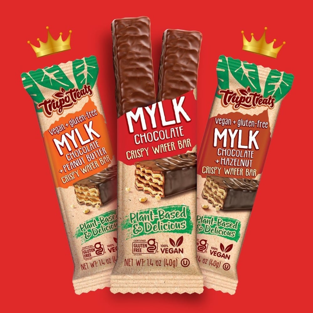 Three Trupo Treats vegan chocolate bars on a red background