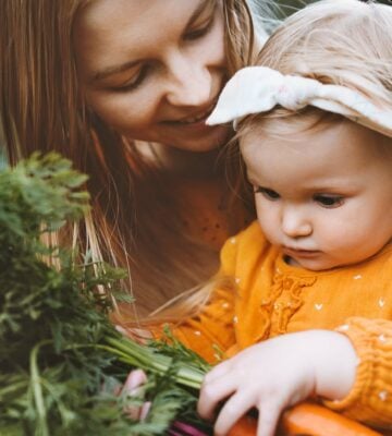 A mum and baby pick vegetables