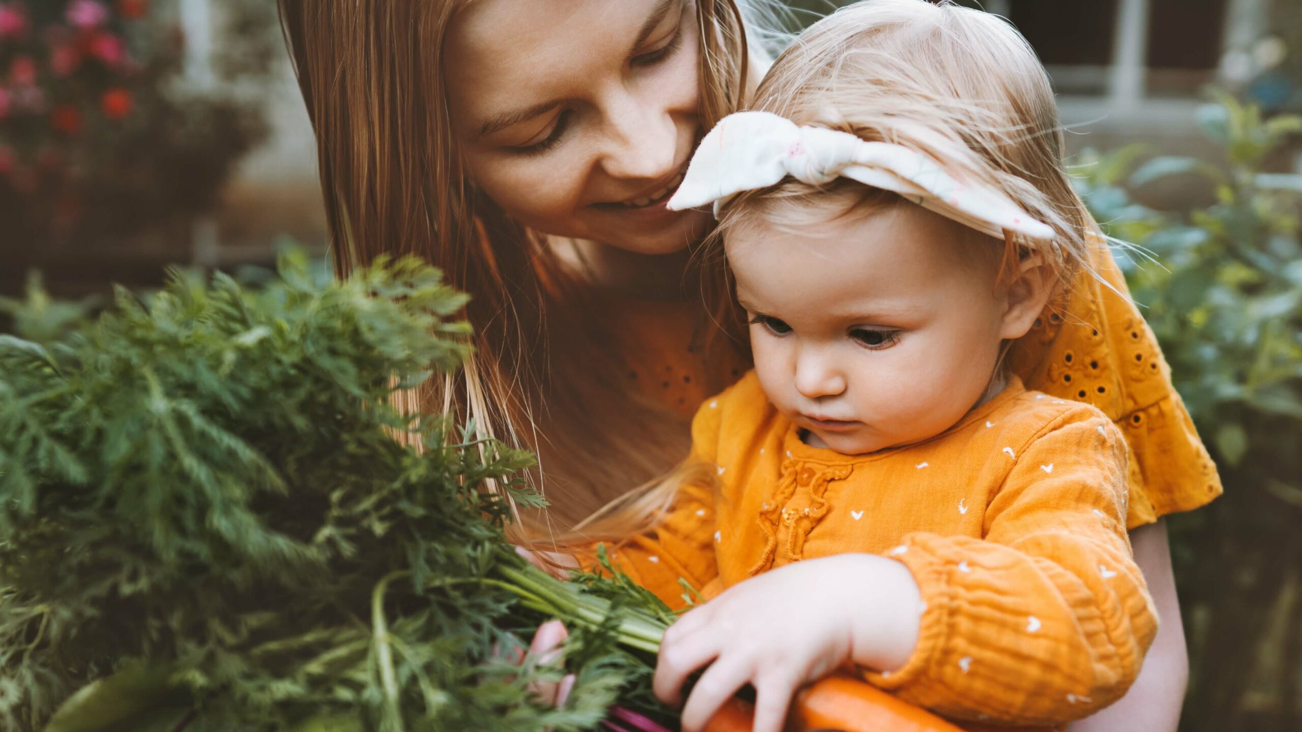 A mum and baby pick vegetables