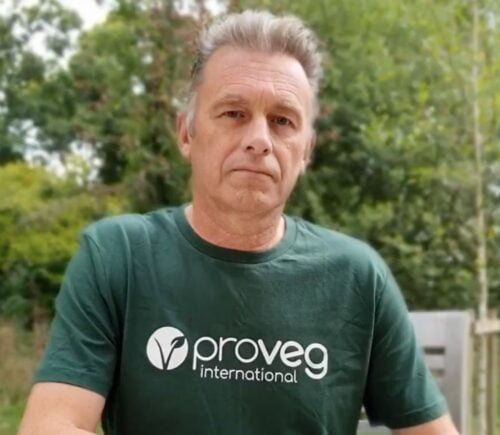 Chris Packham in a Pro Veg t-shirt in a garden