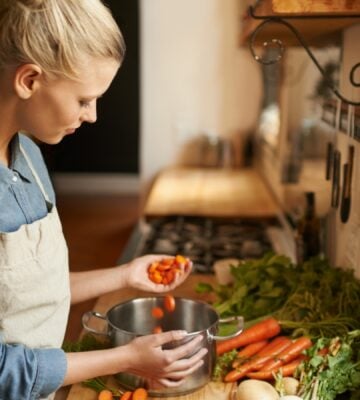 A woman cooking with chopped vegetables