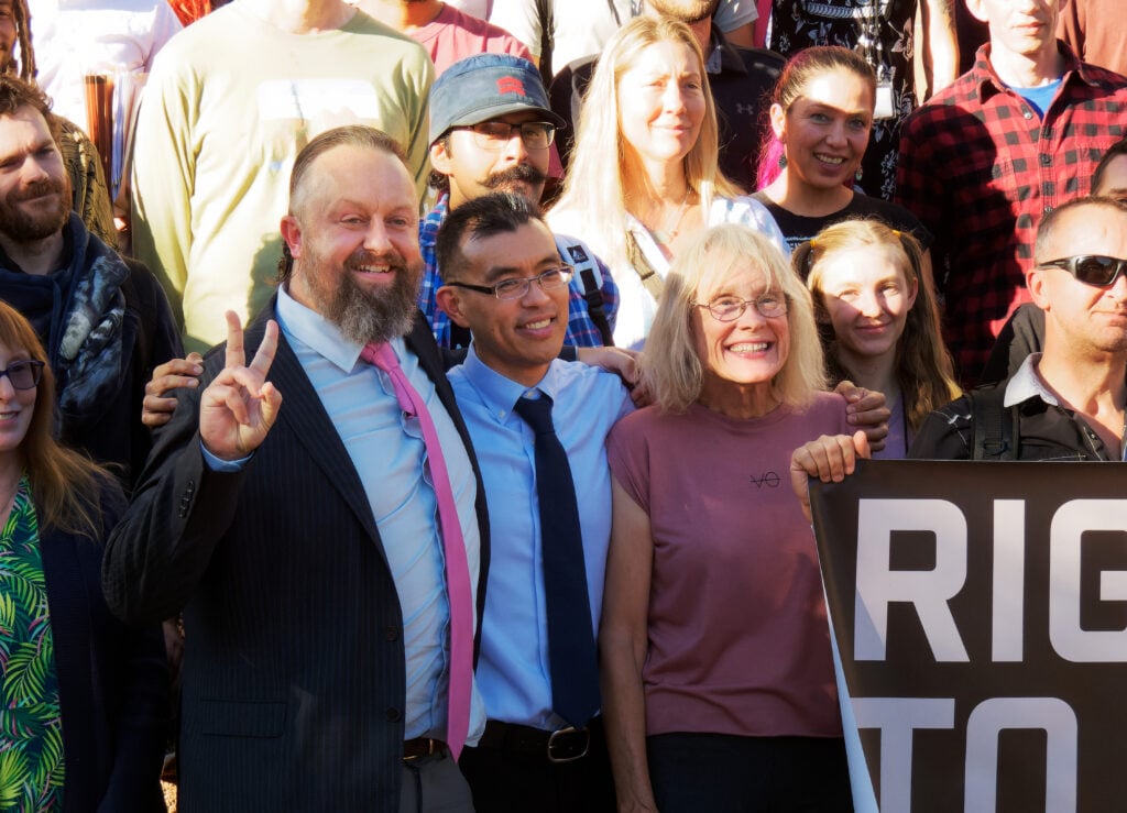 Animal rights activitsts Wayne Hsiung and Paul Darwin Picklesimer pose with supporters outside the courtroom of the Smithfield Trial