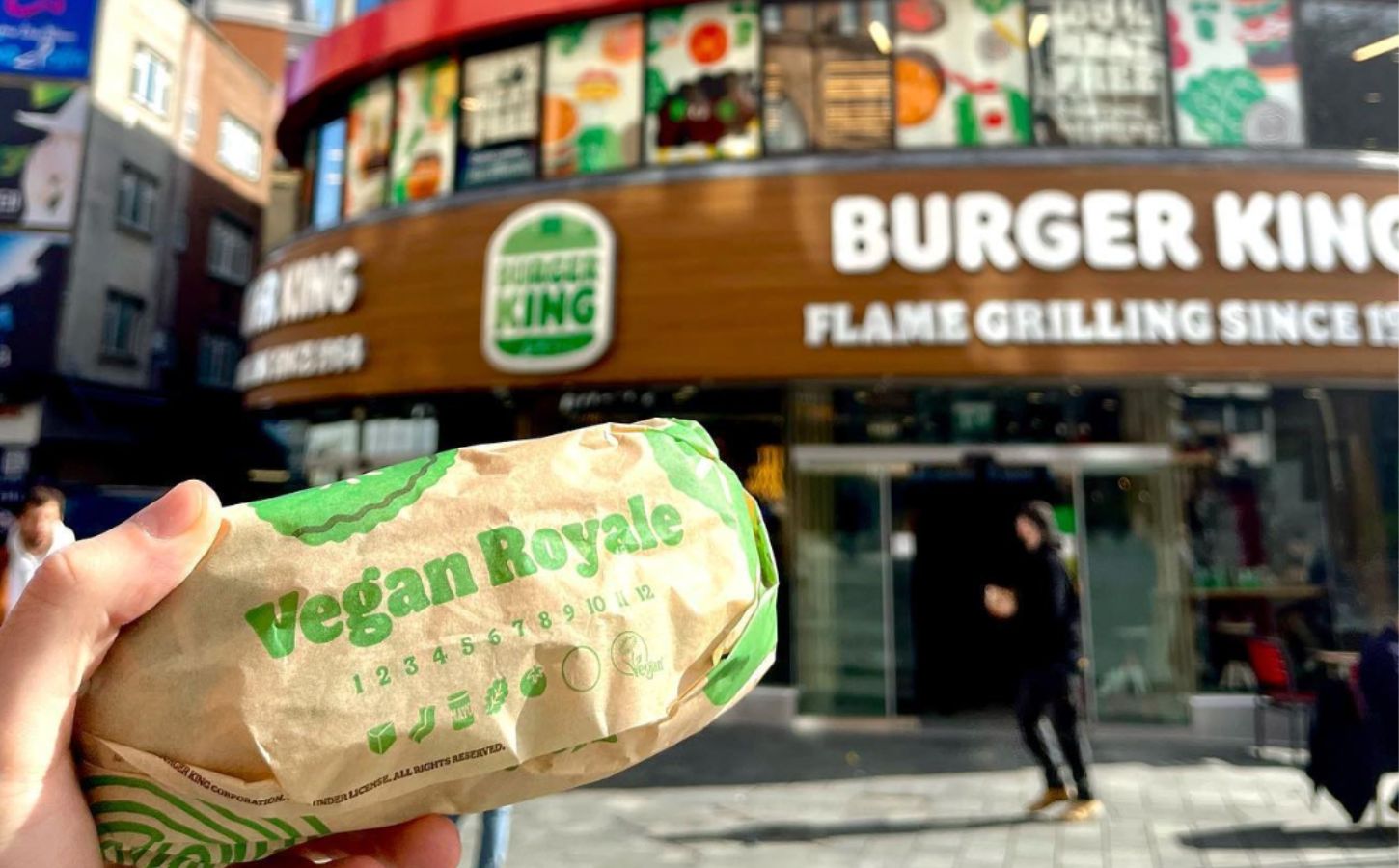 Someone holding a Vegan Royale in front of the vegan Burger King in Leicester Square