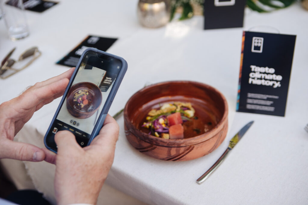 A person takes a picture of a cultivated chicken product at COP26