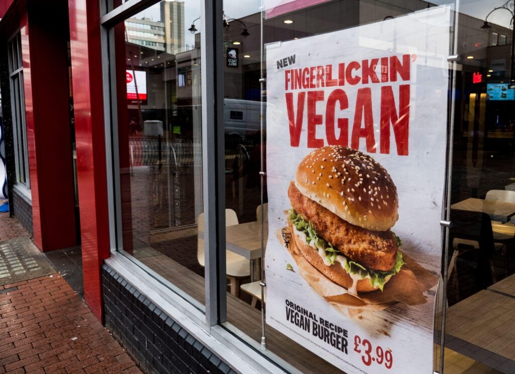 A KFC shop window in the UK displaying an advert for its vegan burger, which features plant-based Quorn meat and vegan mayo